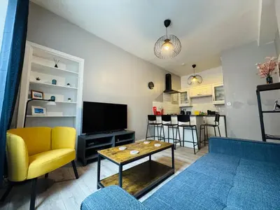 a living room with a couch and a table at Stylish Flat in Historic Edinburgh city centre home in Edinburgh