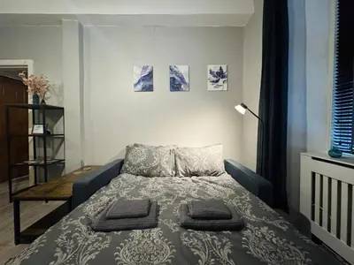 a bedroom with a bed with two pillows on it at Stylish Flat in Historic Edinburgh city centre home in Edinburgh