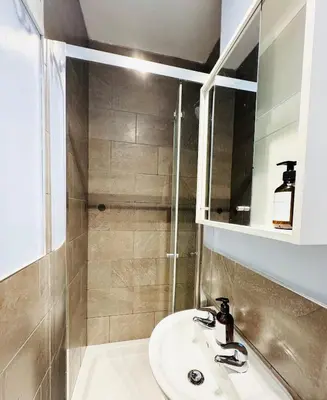 a bathroom with a sink and a shower at Stylish Flat in Historic Edinburgh city centre home in Edinburgh