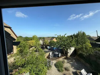 a view from a window of a yard with trees at Cosy Cottage in Cotswolds in Moffat