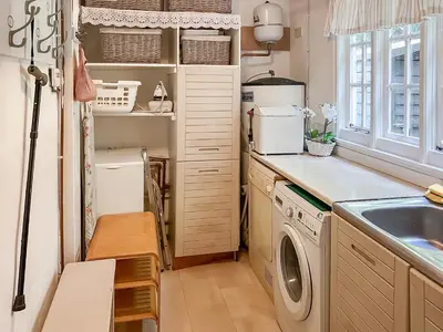 a kitchen with a washing machine and a sink at Tigh An Droma Lodge in Whiting Bay