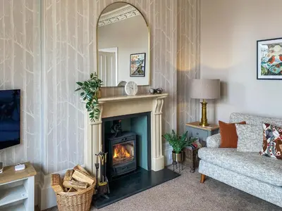 a living room with a fireplace and a couch at Thornlie - Uk49875 in Blairmore