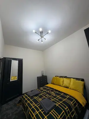 a bedroom with a bed and a ceiling fan at 3BR West End Flat w Free Parkin in Glasgow