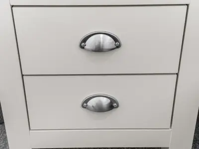 a white chest of drawers with chrome pulls at Ludgate 2 Bedroom Apartment - Alloa in Alloa