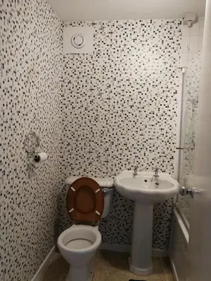 a bathroom with a toilet and a sink at Three Bedroom Apartment Glasgow in Glasgow