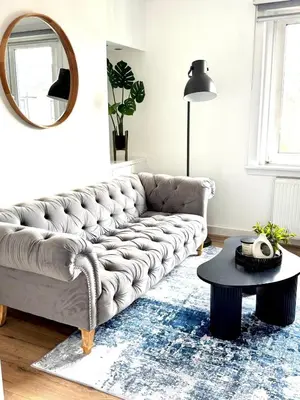 a living room with a couch and a table at Newtown Hideaway in Boʼness