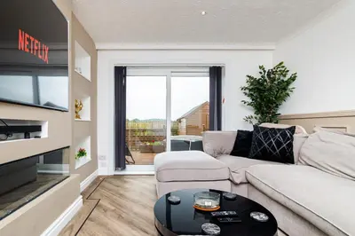 a living room with a couch and a table at 2 Bedroom House-Free Parking in Rosyth
