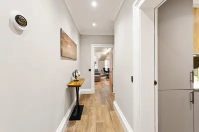 a hallway with white walls and a table in a room at City Centre Luxury Studio for 2 in Edinburgh