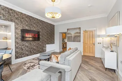 a living room with a couch and a table at Prime Central Edinburgh 1 bed in Edinburgh