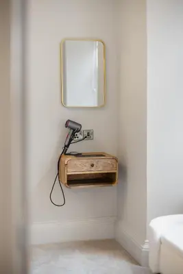 a bathroom with a mirror and a hair dryer at Prime Central Edinburgh 1 bed in Edinburgh