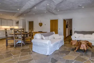 a living room with two white couches and a table at The Warren - Hobbit House and Hot Tub at Loch Tay in Lawers