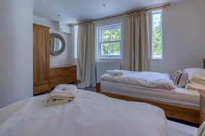 a bedroom with two beds and a window at Loch Tay, Estate House with Panoramic Vistas in Lawers