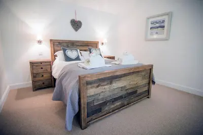 a bedroom with a bed with two pillows on it at Wishing Well Cottage at Loch Tay and Hot Tub in Lawers