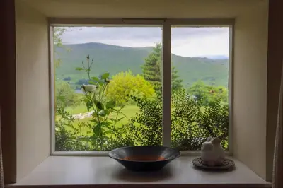 a window with a bowl sitting on a table in front of it at Loch Tay Bothy Cottage with Hot Tub in Lawers