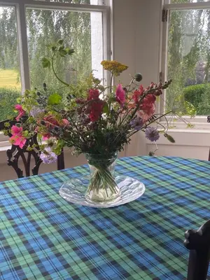 a vase of flowers sitting on a table at Fordie Lodge in Comrie