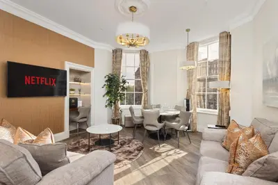 a living room with a couch and a table at Prime Central Edinburgh 2 bed in Edinburgh
