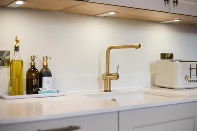 a kitchen counter with a sink and a sink at Prime Central Edinburgh 2 bed in Edinburgh