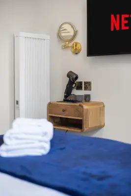 a room with a bed with a camera in a box at Prime Central Edinburgh 2 bed in Edinburgh