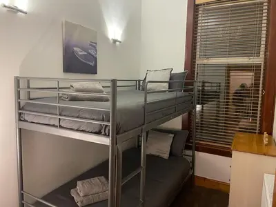 a couple of bunk beds in a room at Quirky Cottage Central Bathgate in Bathgate