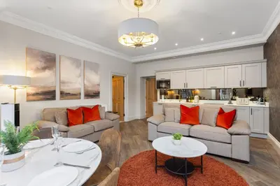 a living room with two couches and a table at Prime Central Edinburgh 3 bed in Edinburgh