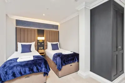 a bedroom with two beds with blue comforters at Central Edinburgh Prime Luxury in Edinburgh
