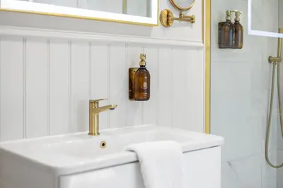 a white bathroom with a sink and a mirror at Central Edinburgh Prime Luxury 3 bed in Edinburgh