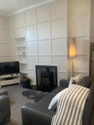a living room with a couch and a fireplace at Highland Hideaway Helensburgh in Helensburgh