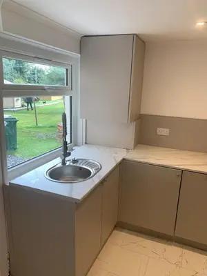 a small kitchen with a sink and a window at Highland Hideaway Helensburgh in Helensburgh
