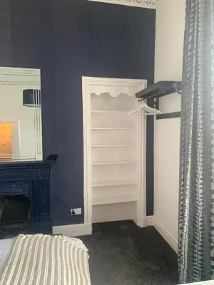 a bedroom with a closet with a bed and a mirror at Highland Hideaway Helensburgh in Helensburgh