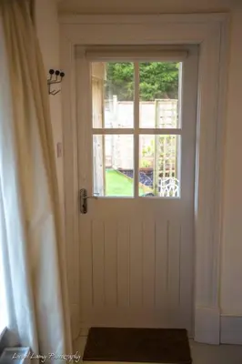 a white door with a window in a room at The Dairy Cottage, Loch Tay, Hot Tub and Garden in Lawers