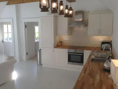 a kitchen with white cabinets and a sink at The Dairy Cottage, Loch Tay, Hot Tub and Garden in Lawers