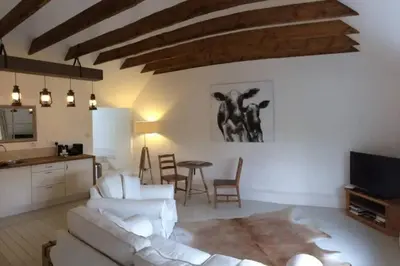 a living room with a white couch and a table at The Dairy Cottage, Loch Tay, Hot Tub and Garden in Lawers