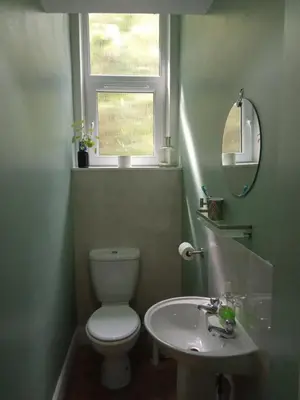 a bathroom with a toilet and a sink and a window at Lovely flat in Gorgie, Edinburgh in Edinburgh