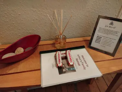 a table with a book and a sign on a table at Lovely flat in Gorgie, Edinburgh in Edinburgh