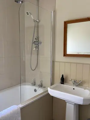 a bathroom with a sink and a shower at Fordie West Cottage in Comrie