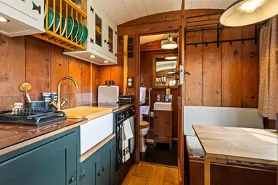 a kitchen with wooden walls and cabinets and a counter top at Redwood in Moffat