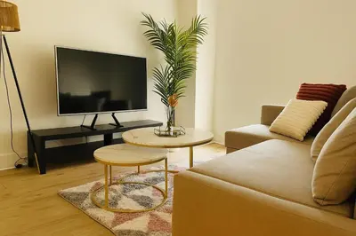 a living room with a couch and a tv at City Central Stay in Glasgow