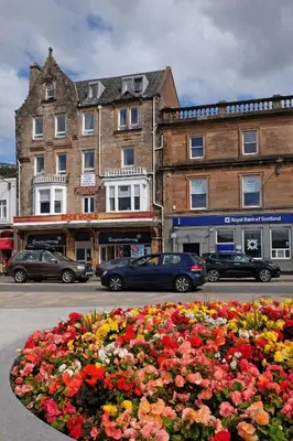 a flower bed in the street in front of a building at Kings Arms Holiday Apartments in Oban