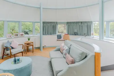 a living room with a couch and a table at Retreat to the Water Tower in Queensferry