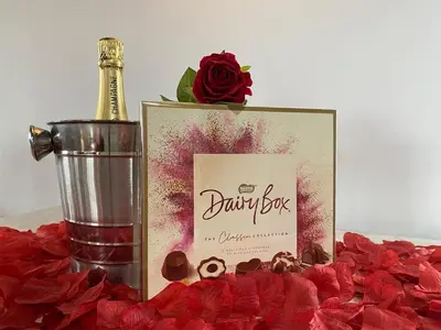 a picture of a bottle of champagne and red roses at Blair snug hut 2 in Kelty