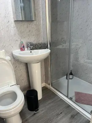 a bathroom with a toilet and a sink and a shower at 3BR Apt Near Ibrox Subway Sleeps 7 and Parking in Glasgow