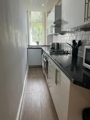 a kitchen with a sink and a counter top at 3BR Apt Near Ibrox Subway Sleeps 7 and Parking in Glasgow