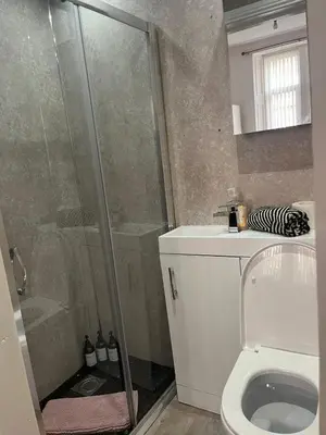 a bathroom with a shower and a toilet at 3BR Apt Near Ibrox Subway Sleeps 7 and Parking in Glasgow