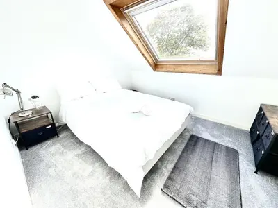 a small bedroom with a bed and a window at Avenue Cottage, Inveraray in Inveraray