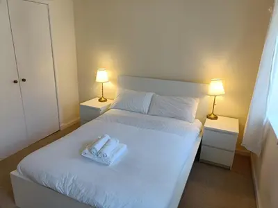 a bedroom with a bed with two towels on it at this flat is permenantly removed from bkngcom list in Moffat