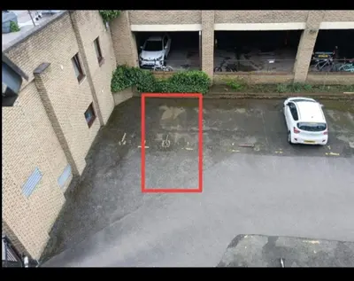 a car parked in a parking lot next to a building at this flat is permenantly removed from bkngcom list in Moffat