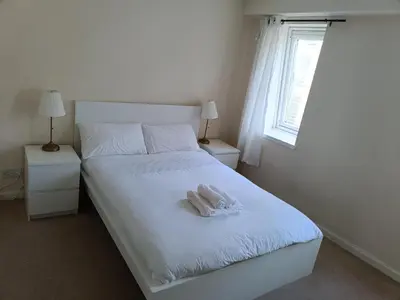 a bedroom with a white bed with a towel on it at this flat is permenantly removed from bkngcom list in Moffat
