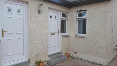 a pair of white doors on the side of a building at My Glasgow House Bishopbriggs in Bishopbriggs