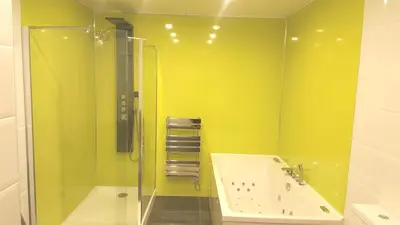 a green bathroom with a tub and a shower at My Glasgow House Bishopbriggs in Bishopbriggs
