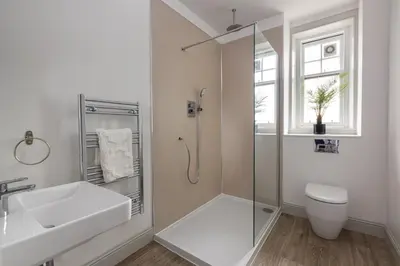 a bathroom with a shower and a toilet and a sink at Antonine Quarters in Grahamston